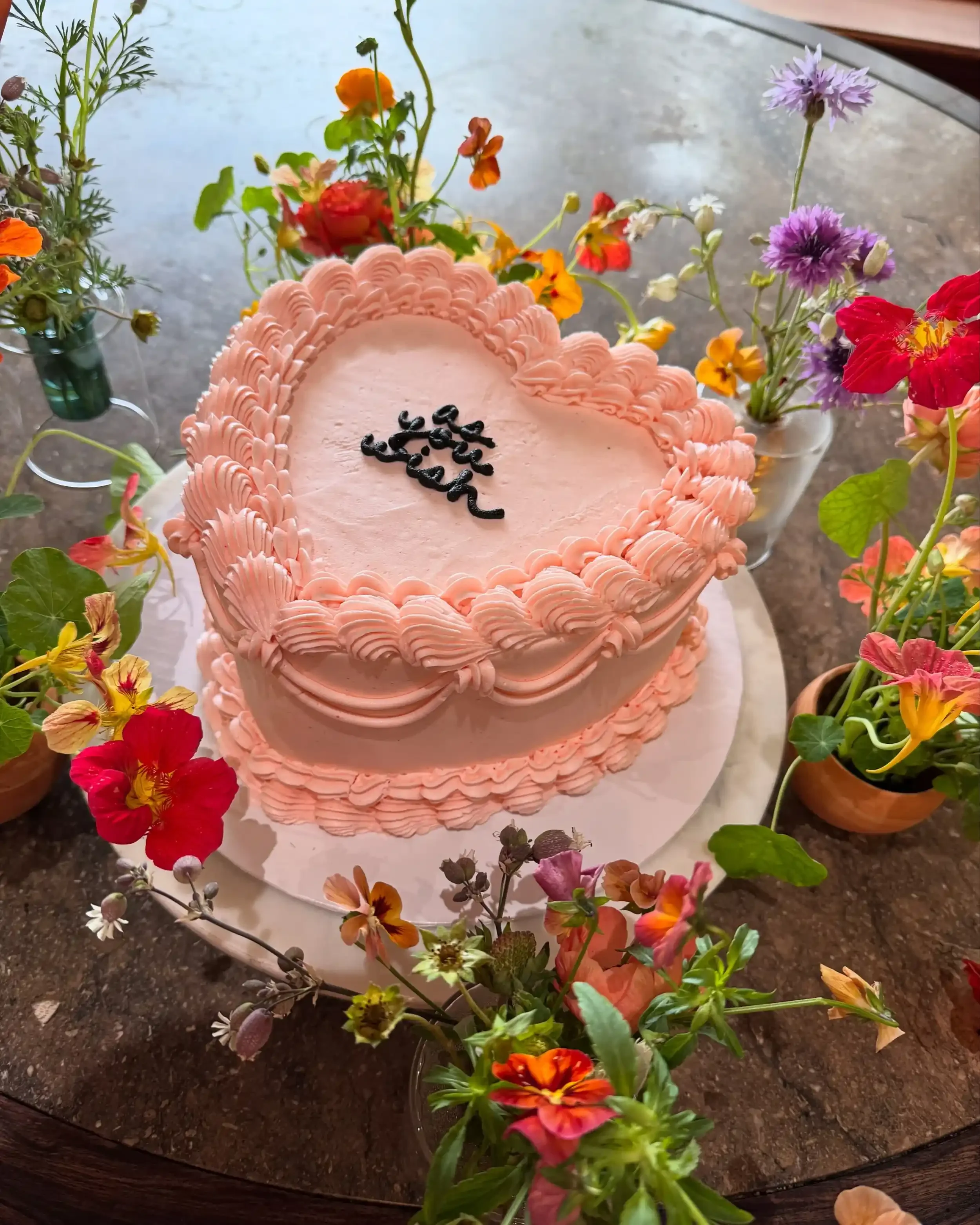 custom Princess Bride wedding cake with pink buttercream inscribed with "as you wish"