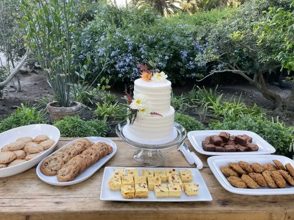 custom tiered floral birthday cake and dessert bar with cookies, brownies, and floral baked goods in SoCal