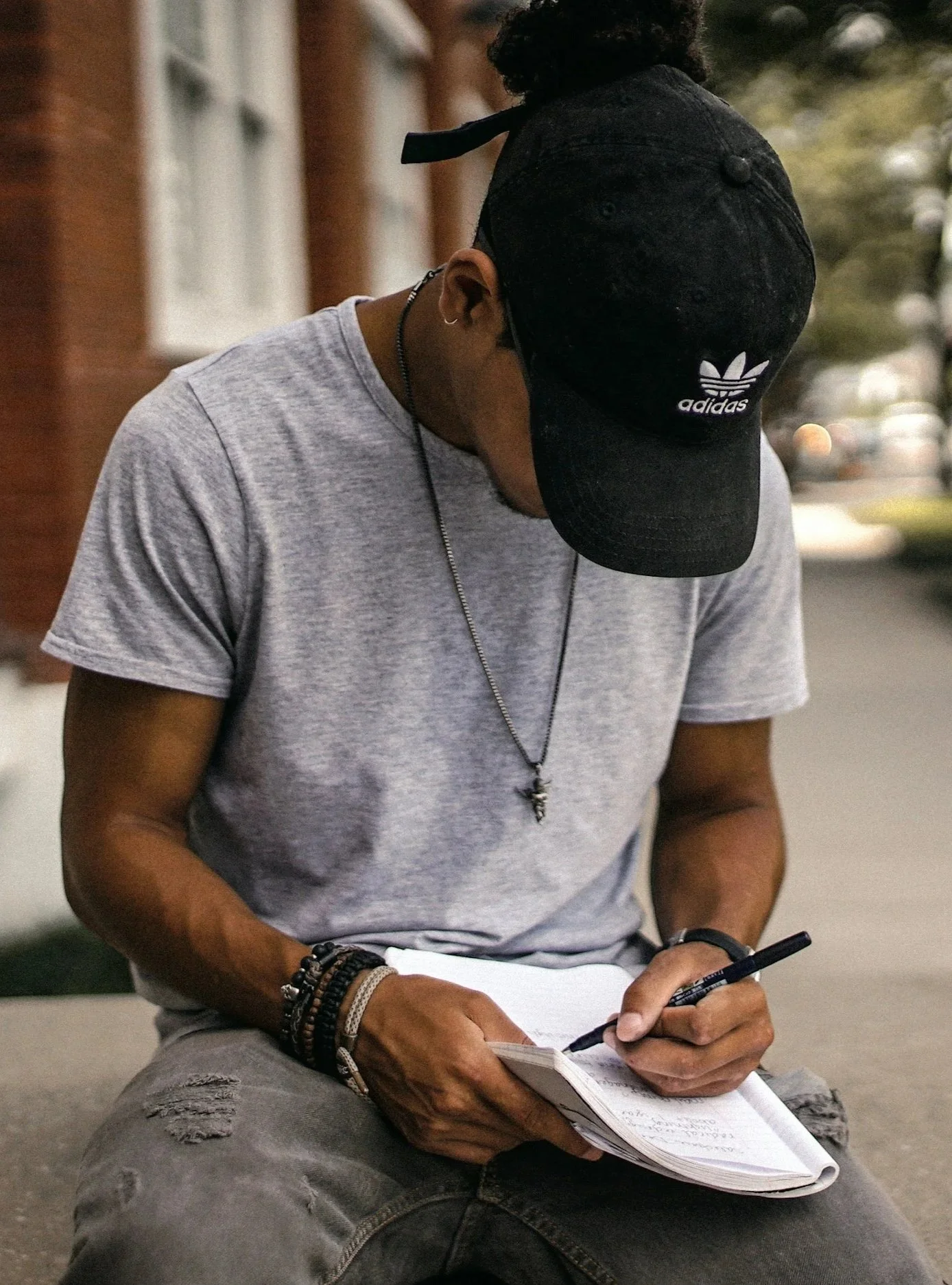 Young man writing in notebook