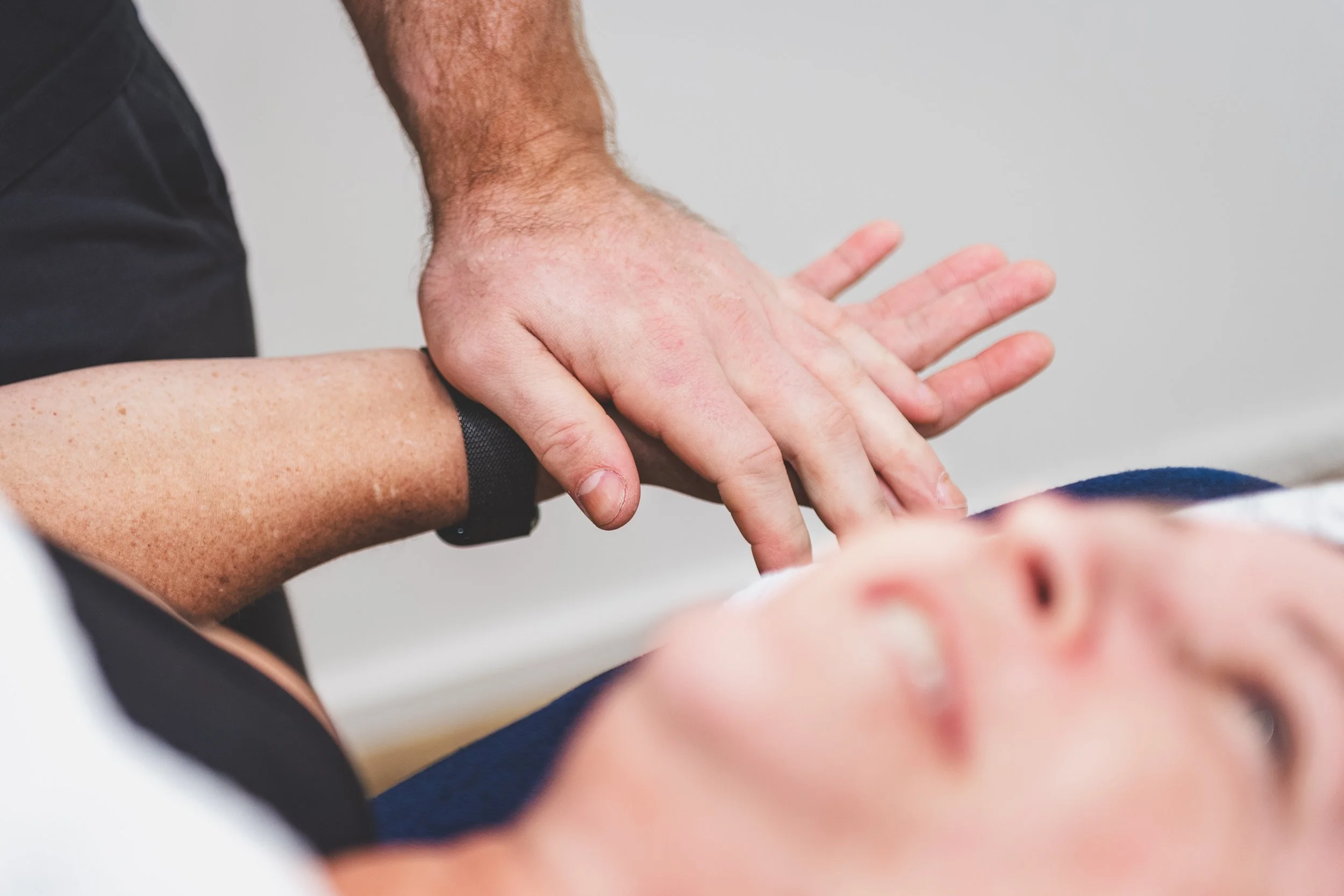 Nick Mann stretching a client's arm and wrist at Mixed Osteo Kensington