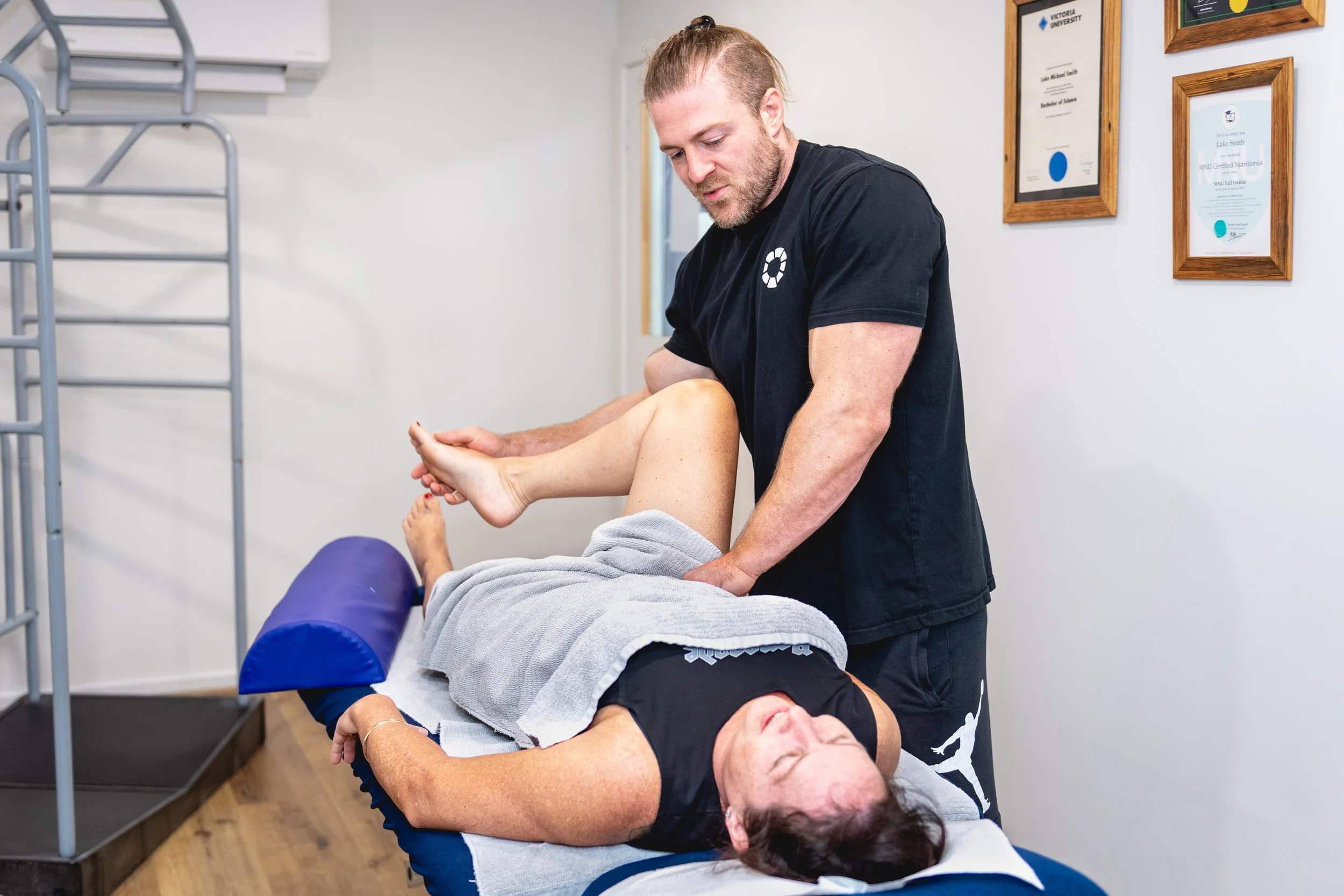 Nick Mann massaging a client's thigh during a remedial massage session at Mixed Osteo