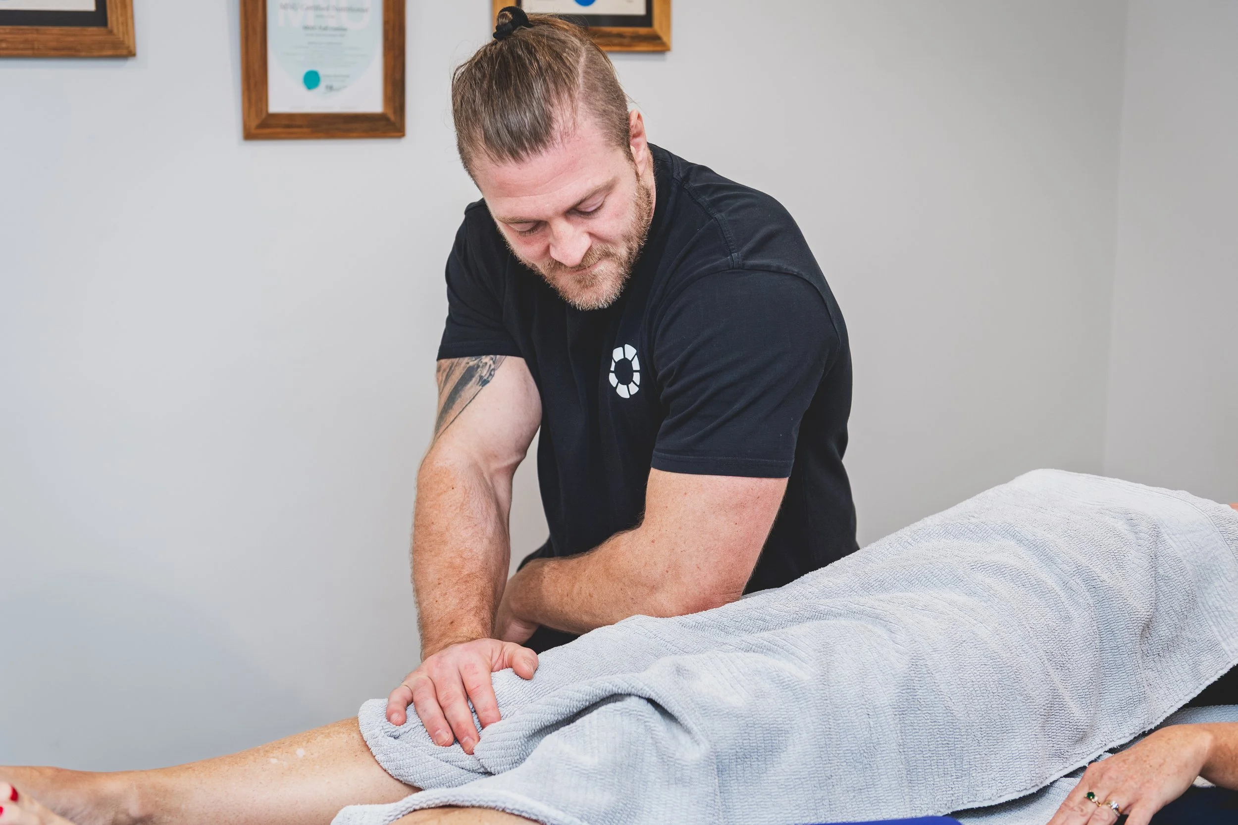 Nick Mann massaging a client's forearm and wrist at Mixed Osteo Kensington