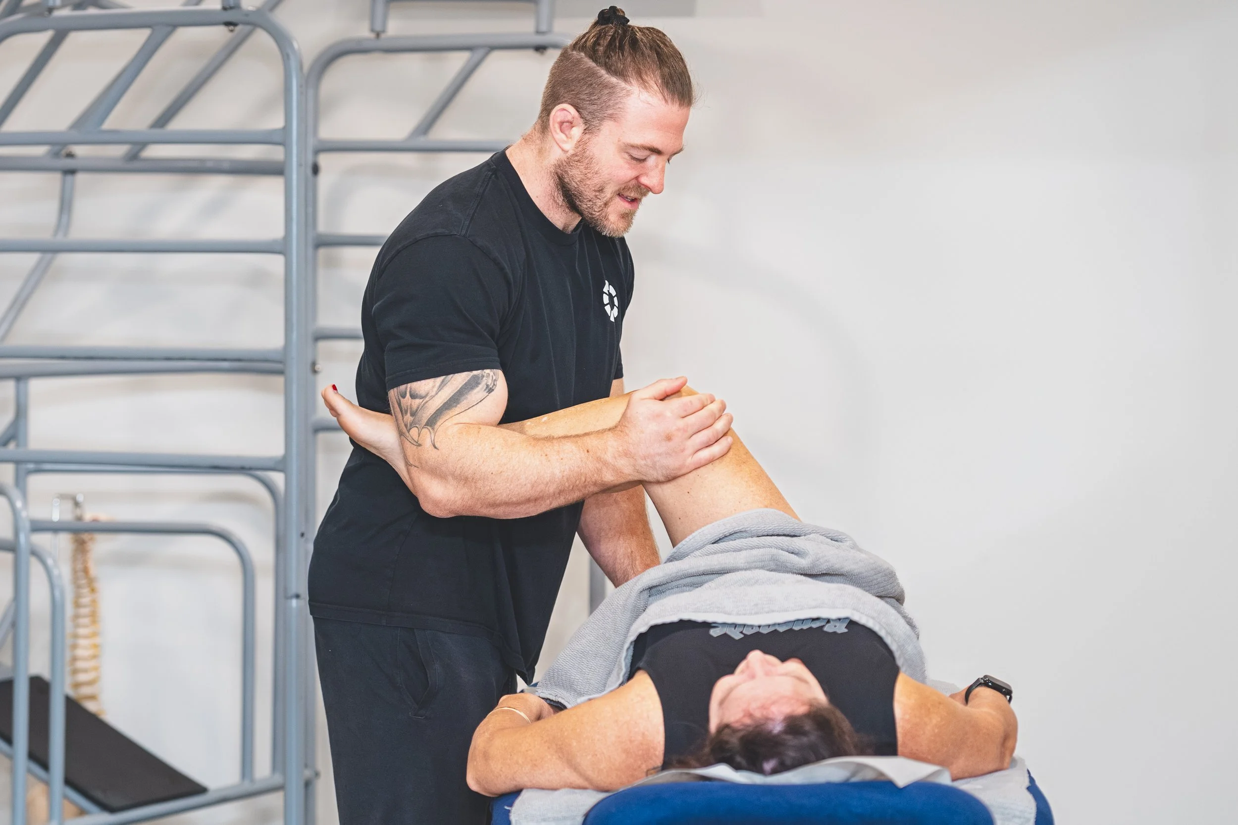 Nick Mann massaging a client's leg during a remedial massage session, Mixed Osteo Kensington