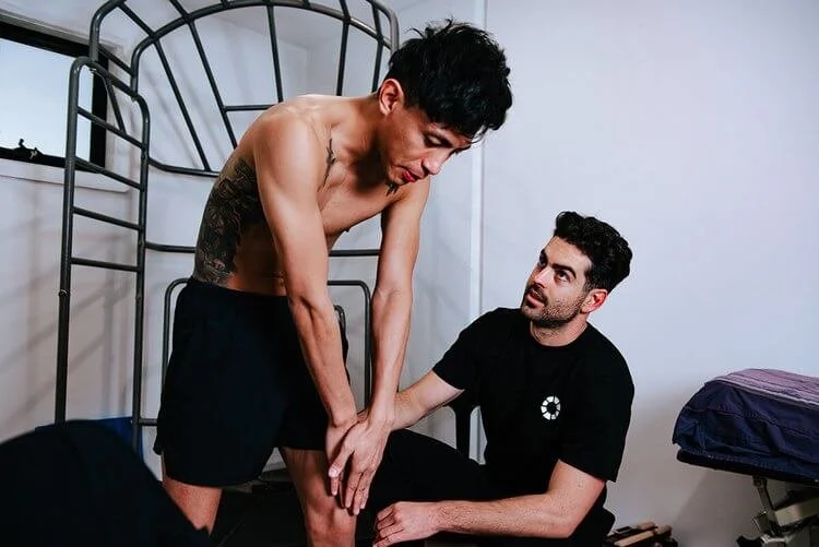 Osteopath assessing a patient's knee