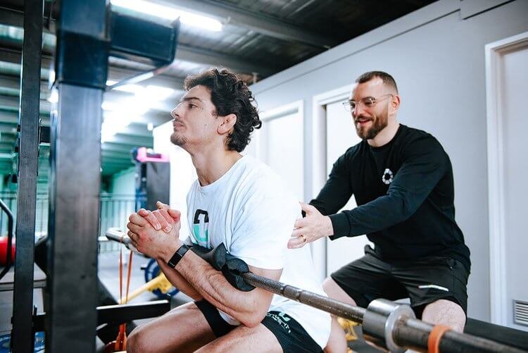 Patient performing a guided rehabilitation exercise with an osteopath at Mixed Osteo