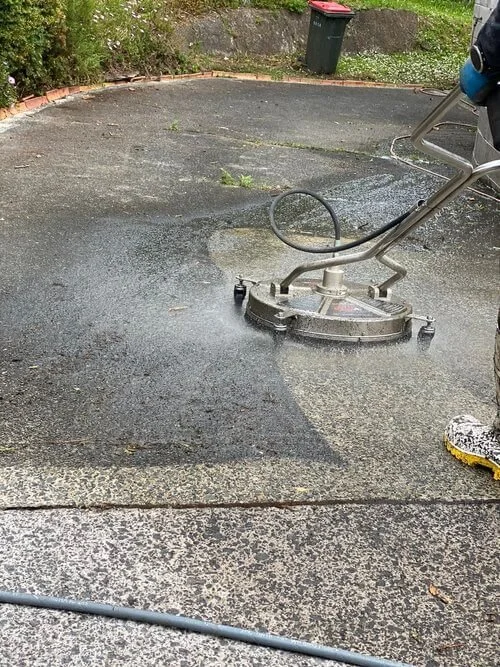 Path and driveway being cleaned by a technician at DCW Services