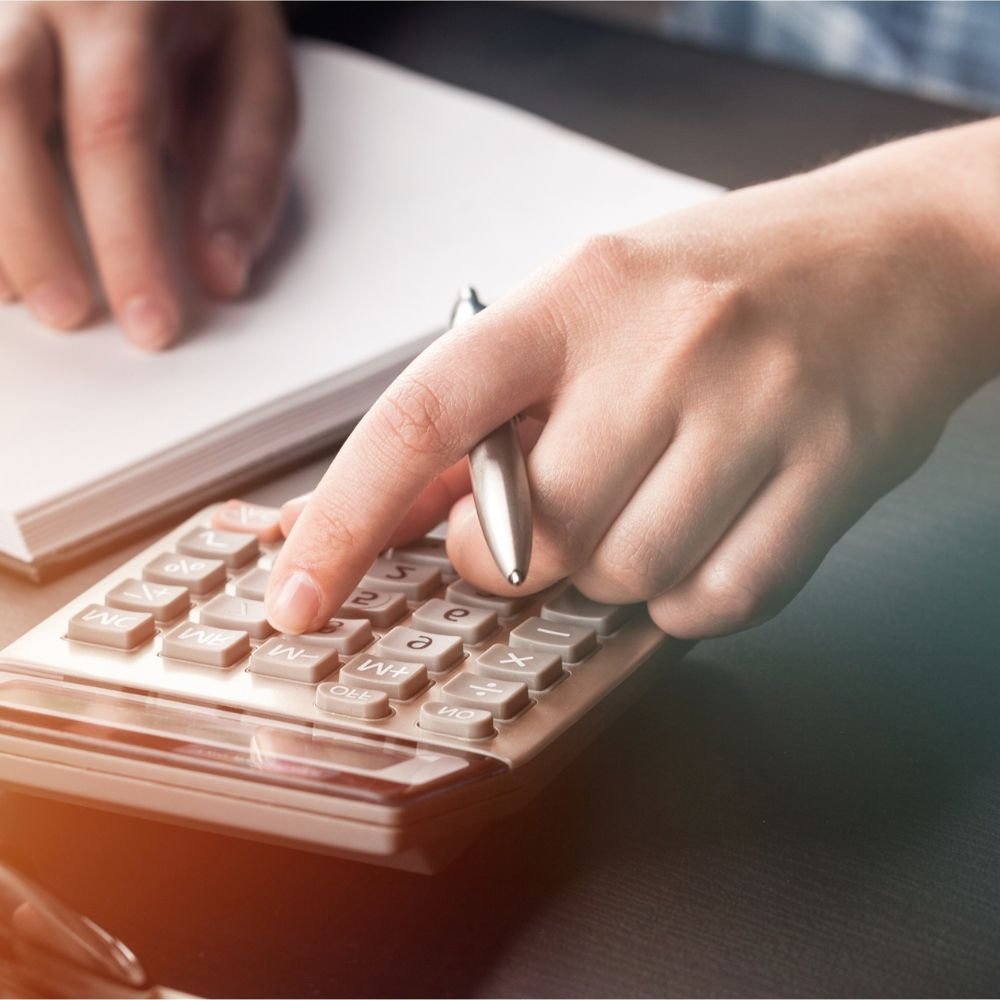 Close up of a person using a calculator for the Payroll Administrator Apprenticeship