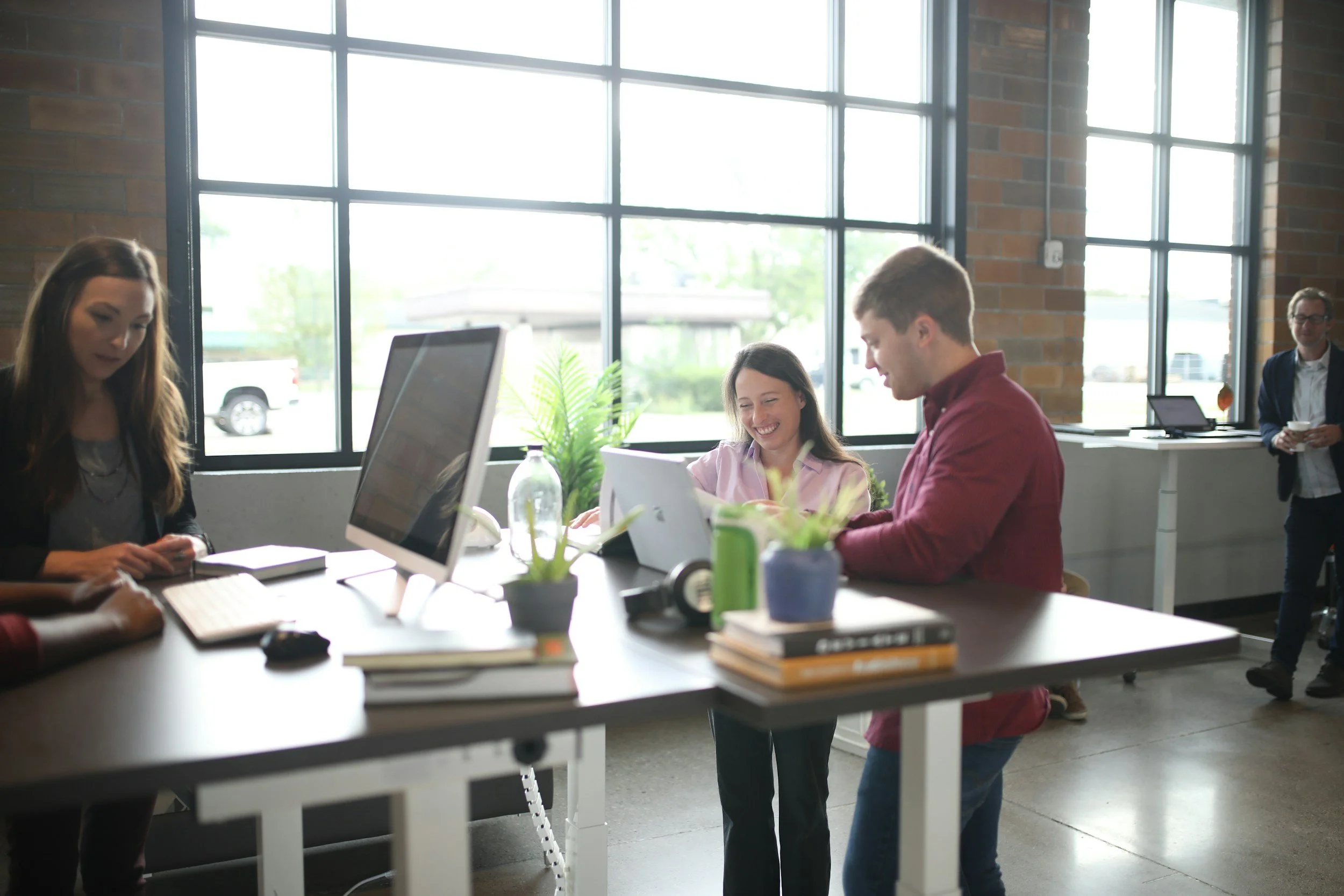 People working together smiling at a laptop