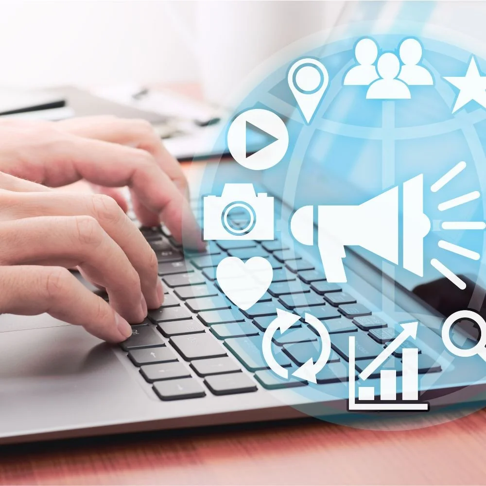 Close up of a person's hands typing on a laptop with various communication symbols pooping out from the screen for the multi-channel marketer apprenticeship