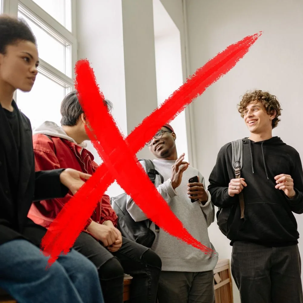 School students in their late teens with a red cross over the image to represent Apprenticeship myths