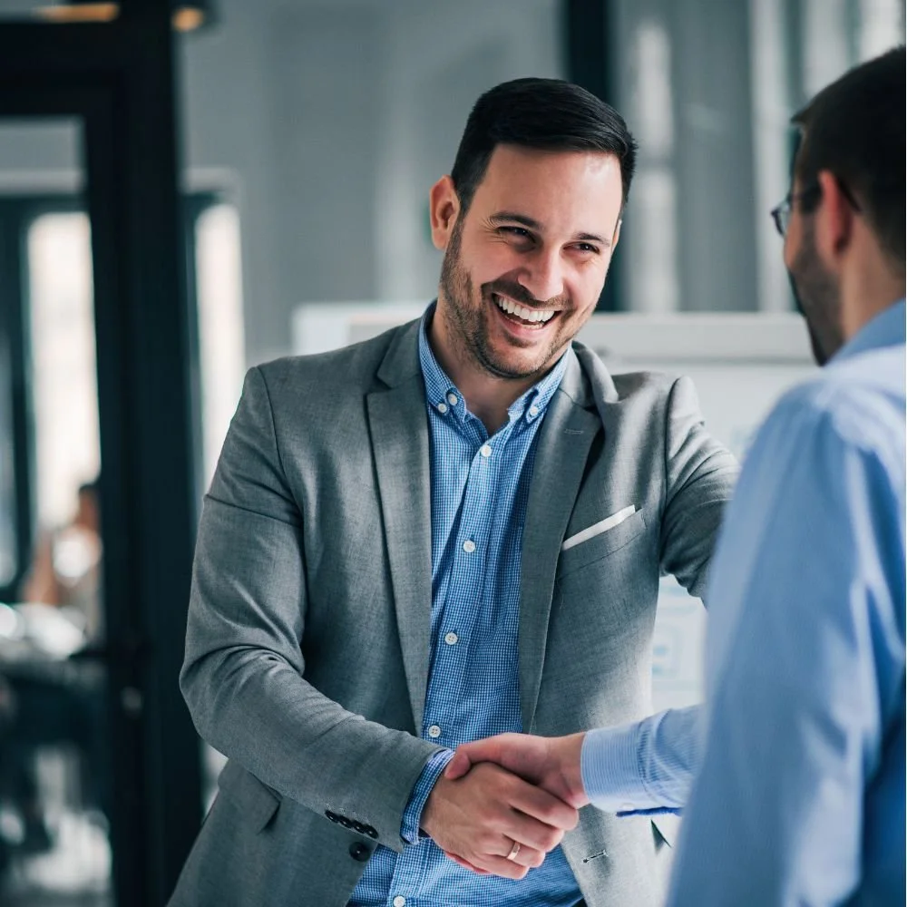 Male new starter shaking hands with the male boss in an office environment