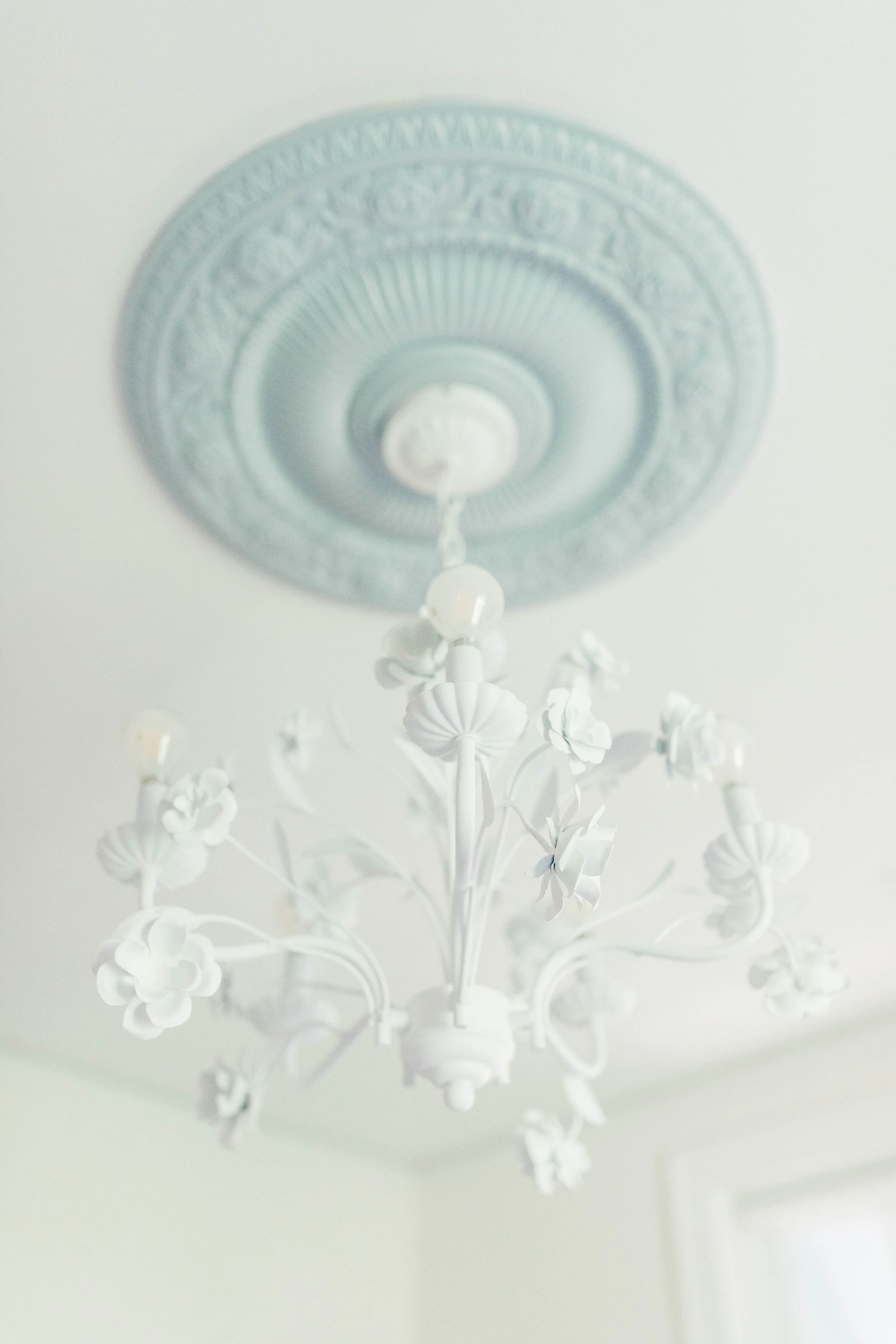   This ceiling medallion was originally in the kitchen. I saved it, painted it blue and moved it to the bedroom to give this chandelier an even more dramatic effect.  