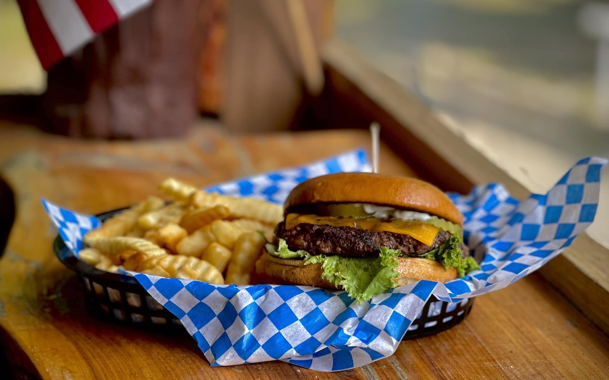 Freshly handmade burger and fries in basket at Lakeside Bar and Grill in Sawyer, OK