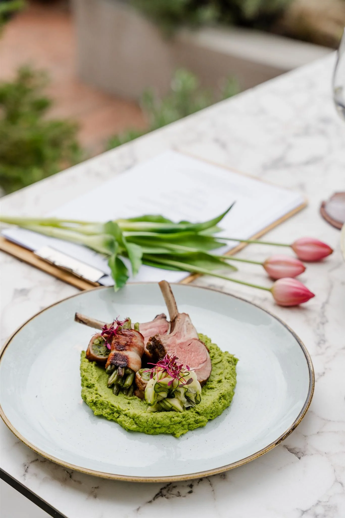 Lamb chops with minty green pea purée and marinated zucchini on the terrace of Andrássy Garden.