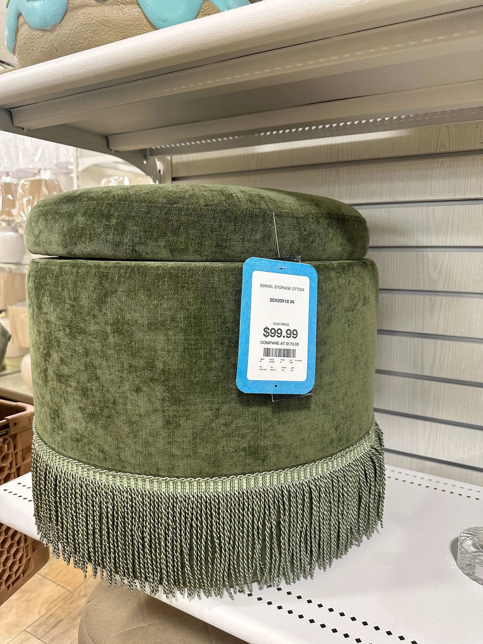 Sage green velvet ottoman with fringe detail showing stylish dorm room decor ideas for c.ollege dorm room