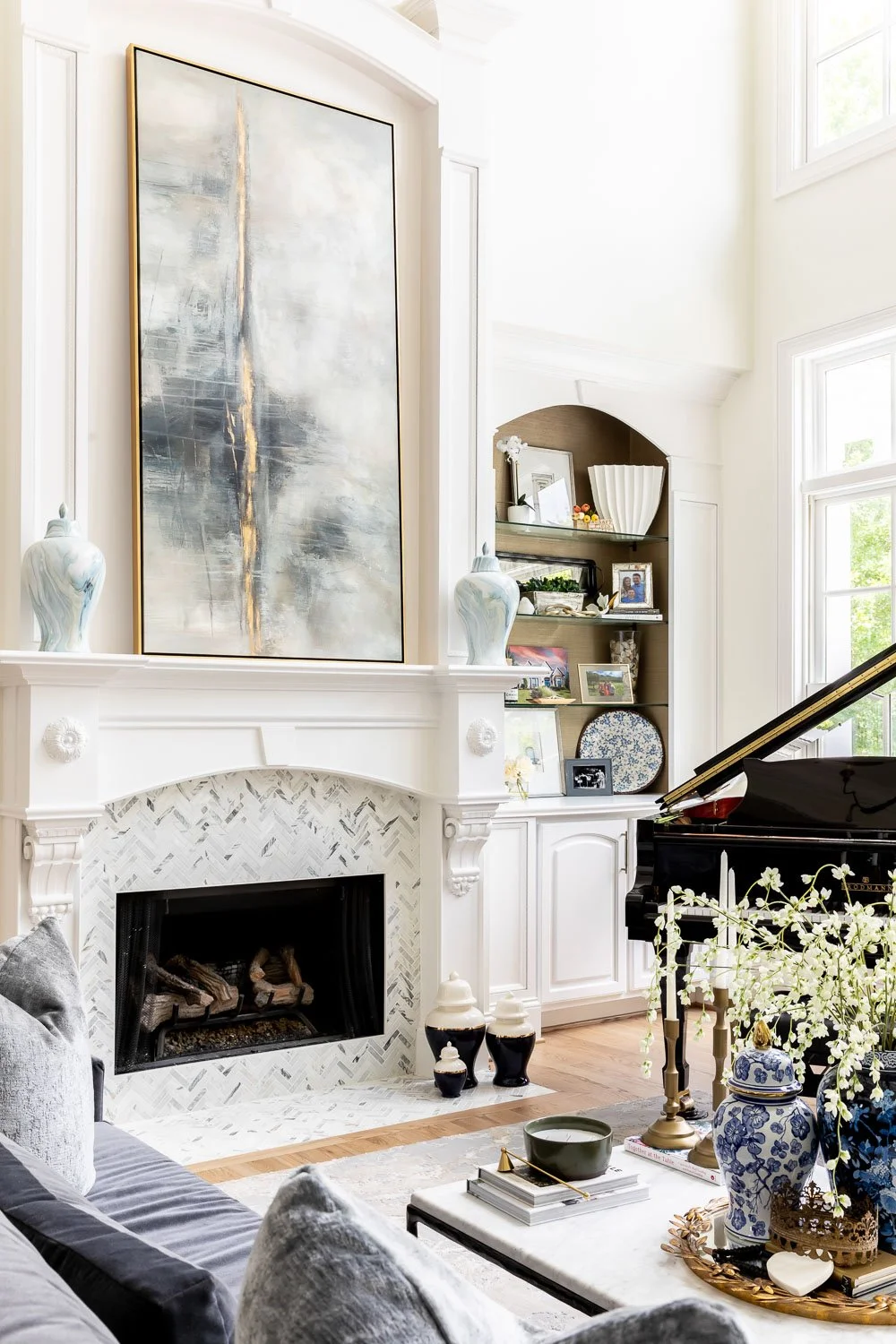  Interior design living room with a custom built-in cabinet flanking a white stone fireplace, warm paint tones, and layered textures reflecting timeless interior design trends for interior design. 