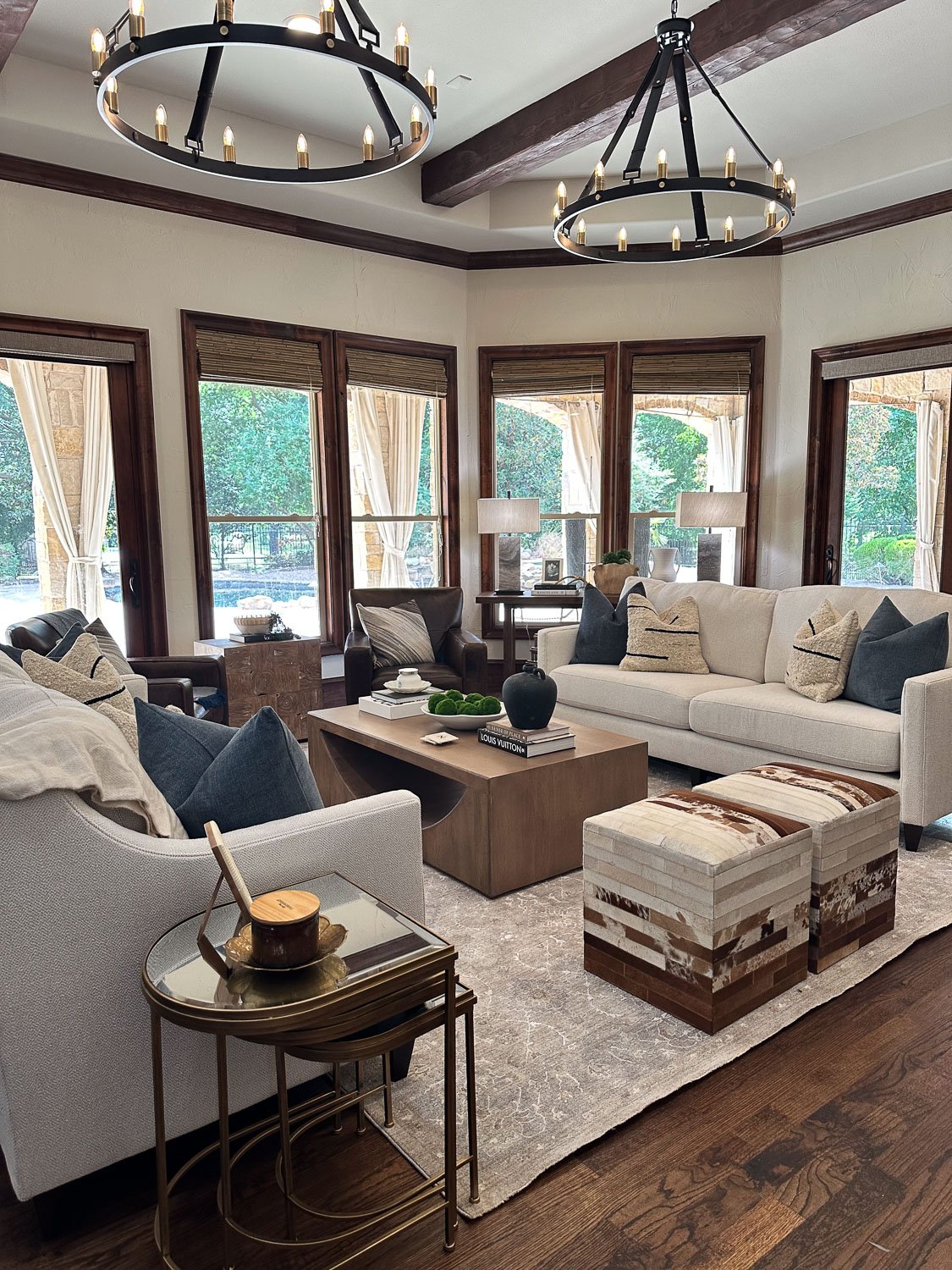 After photo of a living room refresh featuring updated light fixtures, fresh furnishings, and a polished room makeover.