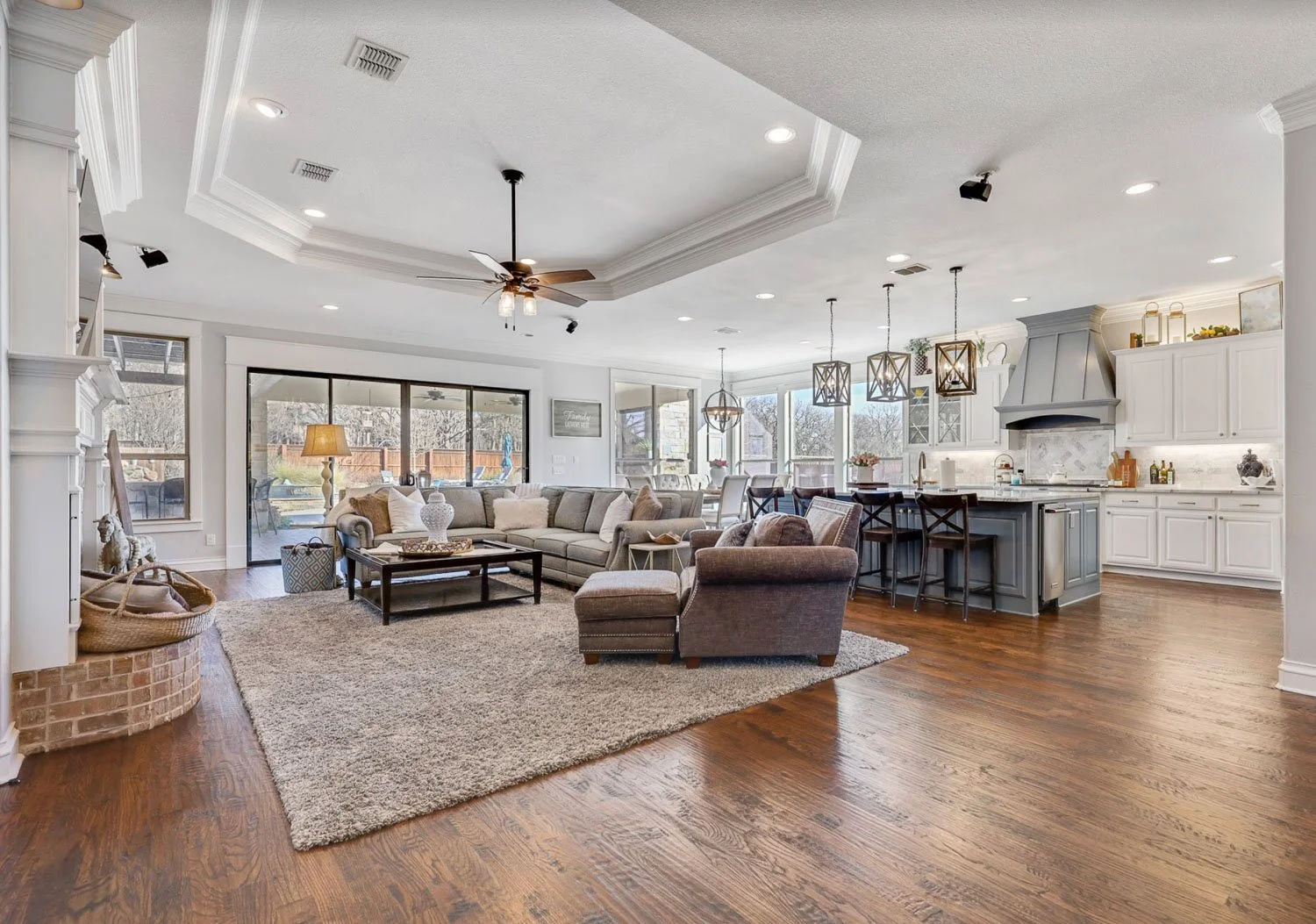 Open concept floor plan with warm paint tones, coffered ceilings, and timeless interior design in a farmhouse home.