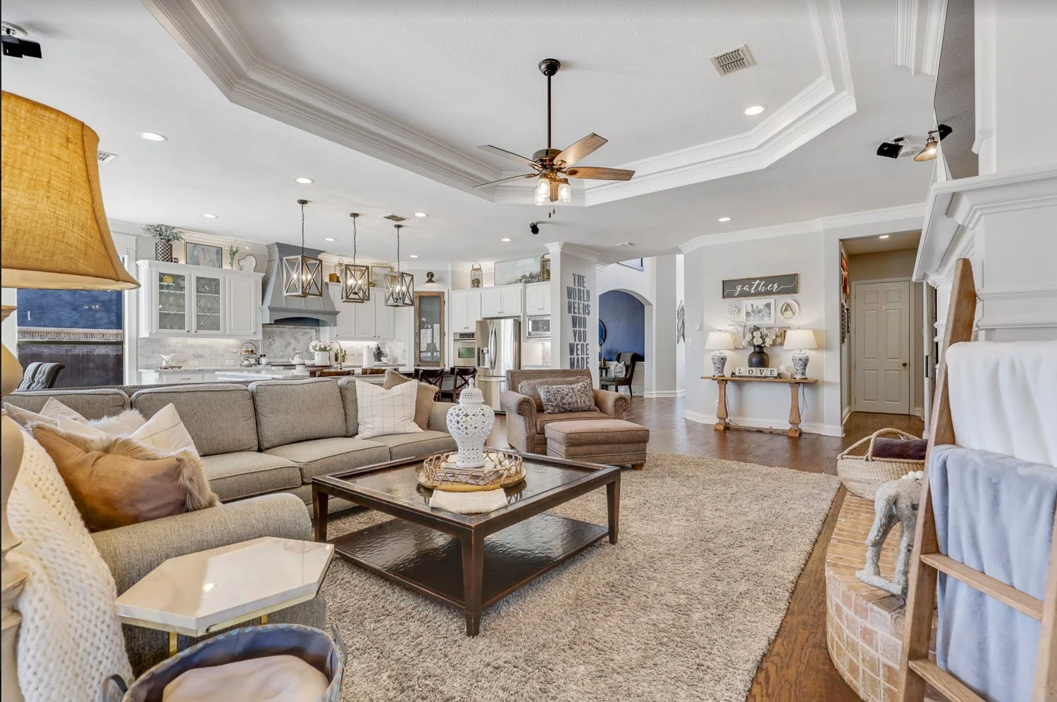 Open concept living space with farmhouse interior design, neutral tones, and custom built in cabinetry.