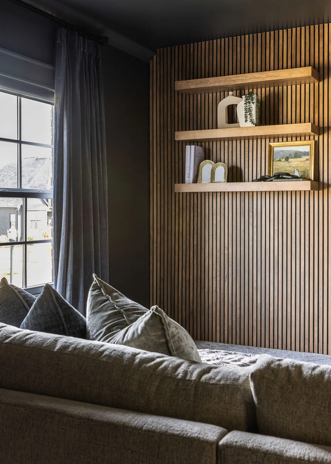 Media room idea inspiration with wood slats and shelving.