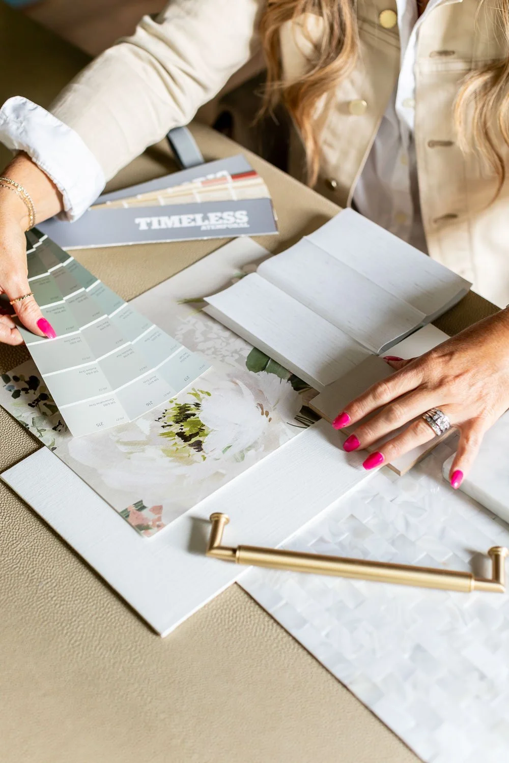 Overhead shot of designers working with blueprints and samples for an inside look at the interior design process.