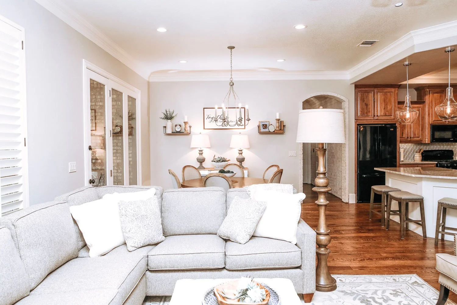 Living room featuring gray paint and warm paint tones with open concept floor plan connecting to the kitchen.