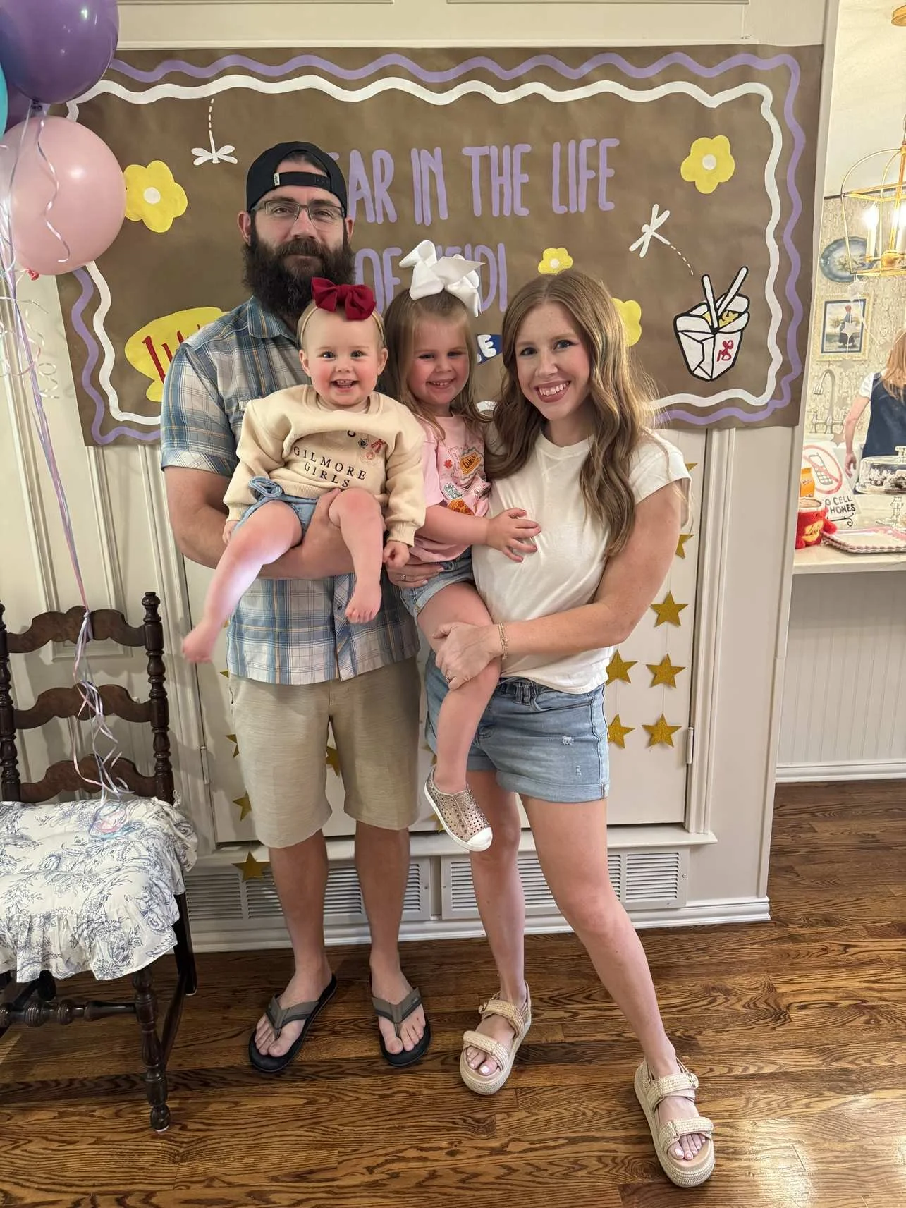 Family photo of busy mom with husband and two young daughters interior decorating tips for busy moms.