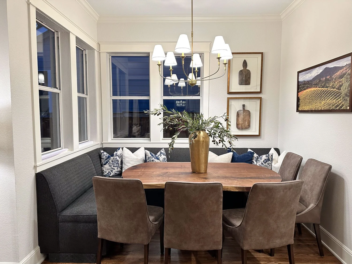 After photo of a beautiful dining room makeover with modern room design elements and updated lighting fixtures.