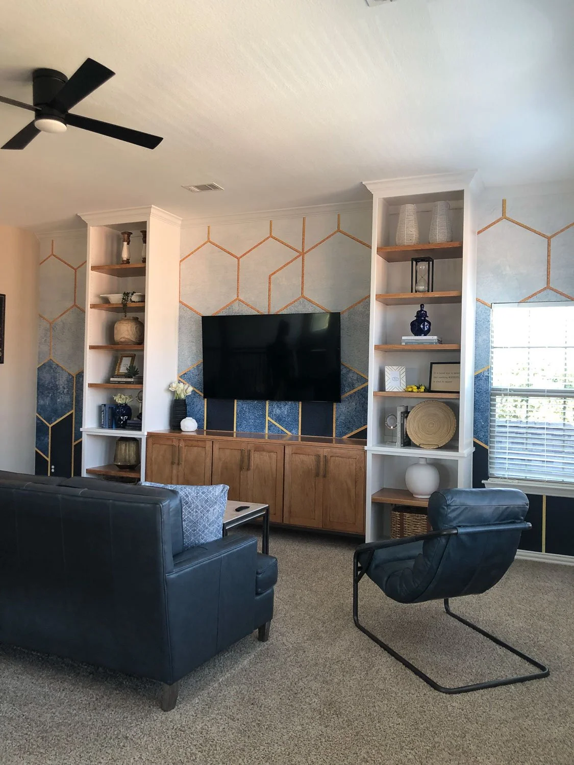 After photo of a living room refresh featuring updated light fixtures, fresh furnishings, and a polished room makeover.