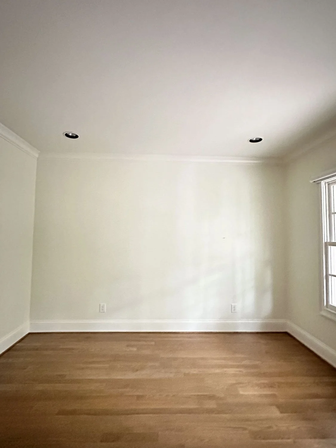Room makeover before photo showing an empty, dated space ahead of a full interior design transformation.
