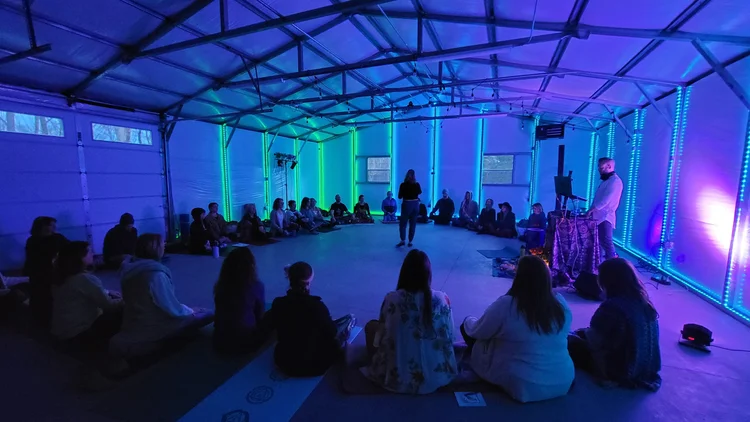 Katie Sutton leading a meditation to open an ecstatic dance