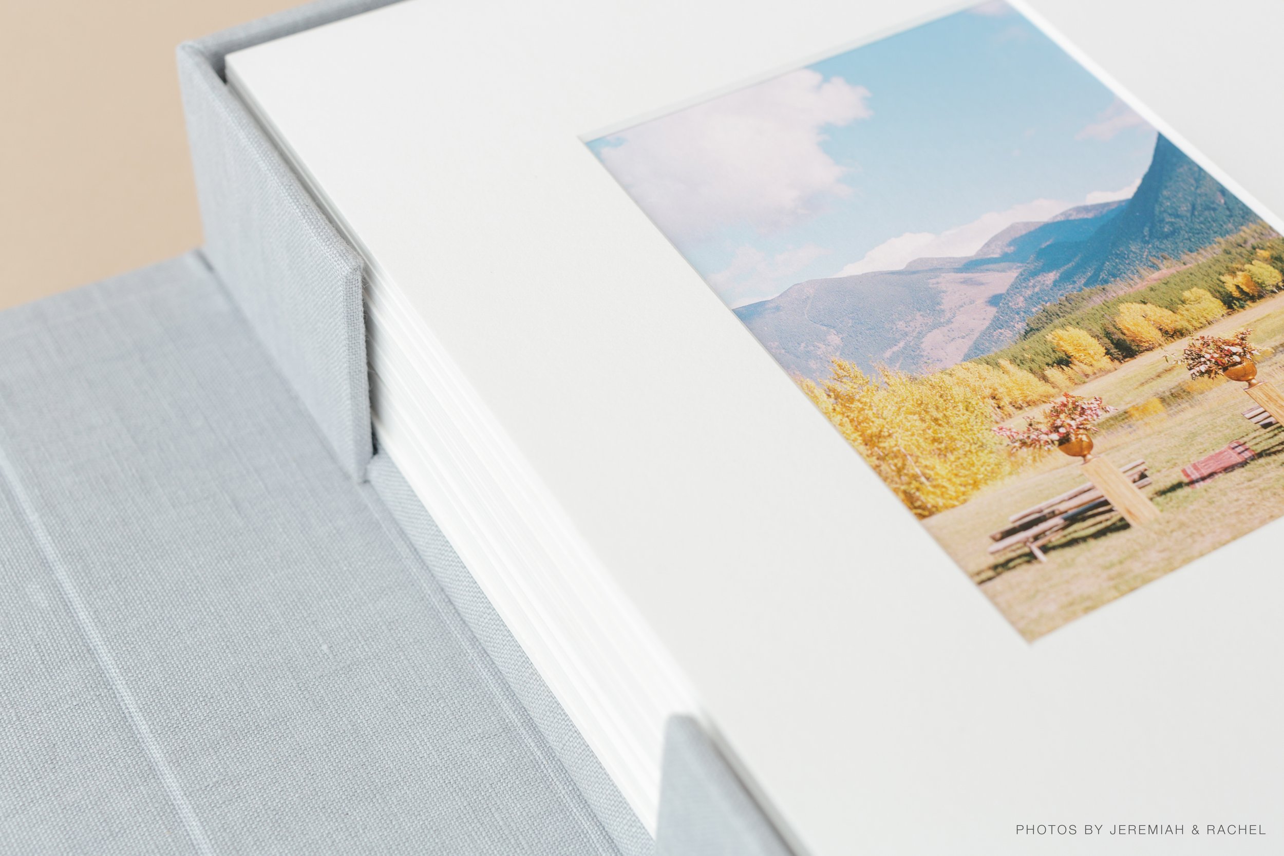 Matted photo prints in a grey folio box