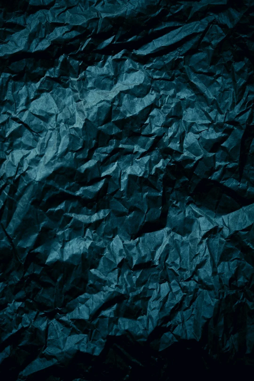 Close-up of crumpled dark blue paper.
