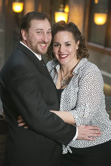 A portrait of a man and a woman in formal attire in the World Trade building in Montreal.