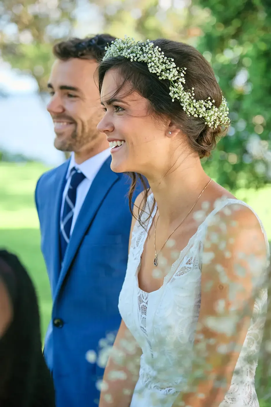A candid photo of a smiling bride with her groom in the background at the Forest and Stream club in Dorval, near Montreal.