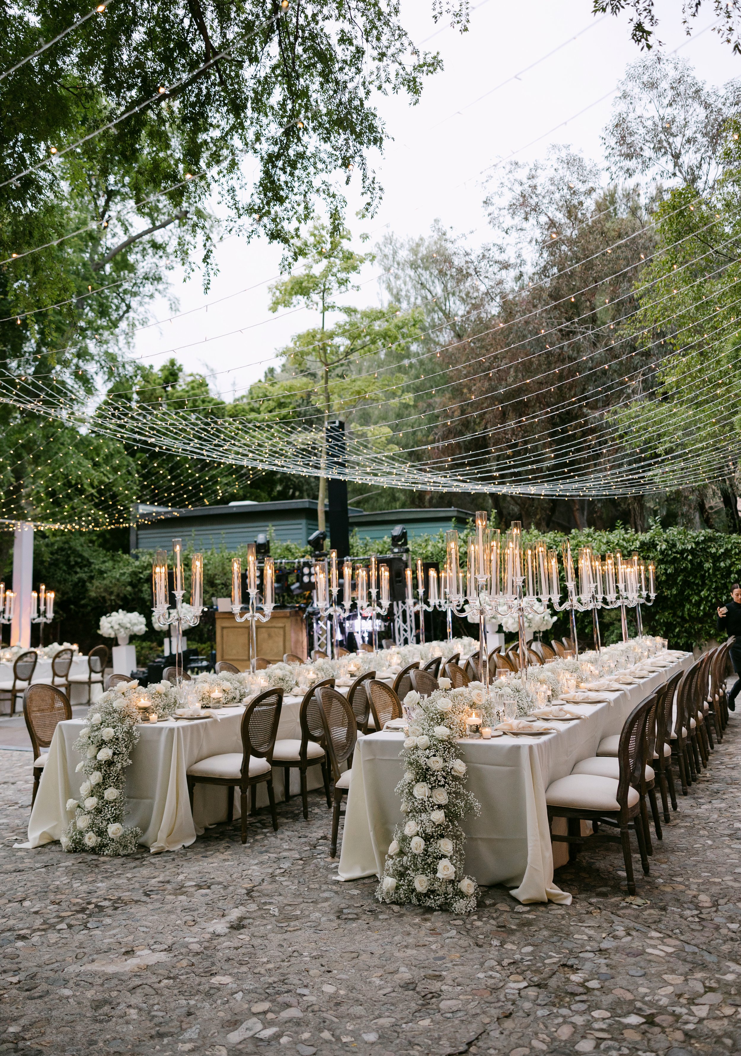 twinkle light canopy, king louis chairs, rectangular tables, rustic tessa bar as dj, white hi gloss pedestals.jpeg