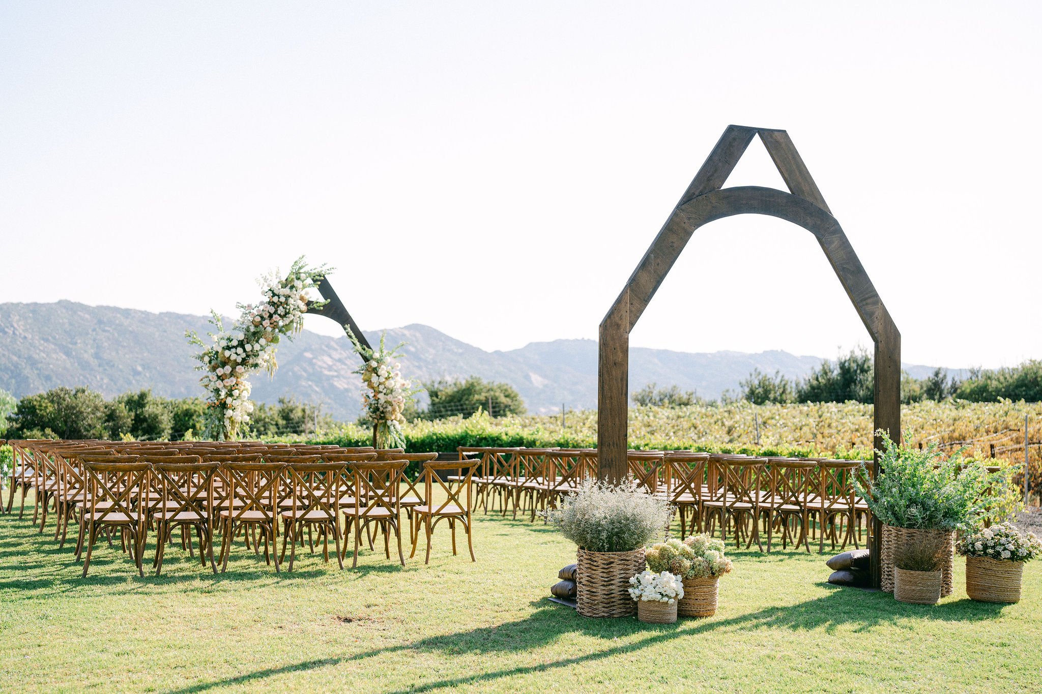 vineyard chairs and custom arches.jpg