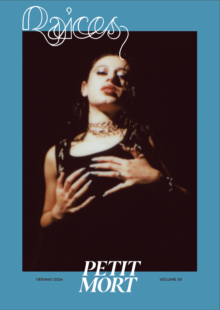 A woman with dark hair and makeup posing with her hands on her chest, wearing a black top and jewelry, with a dark background. The image has a neon-style text that reads 'Poices' at the top and mentions 'Petit Mort' at the bottom.