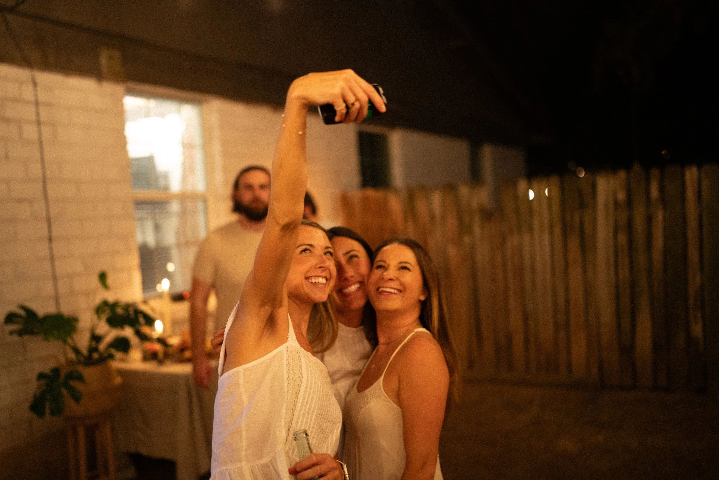 Documentary style wedding photography of couple celebrating engagement with loved ones