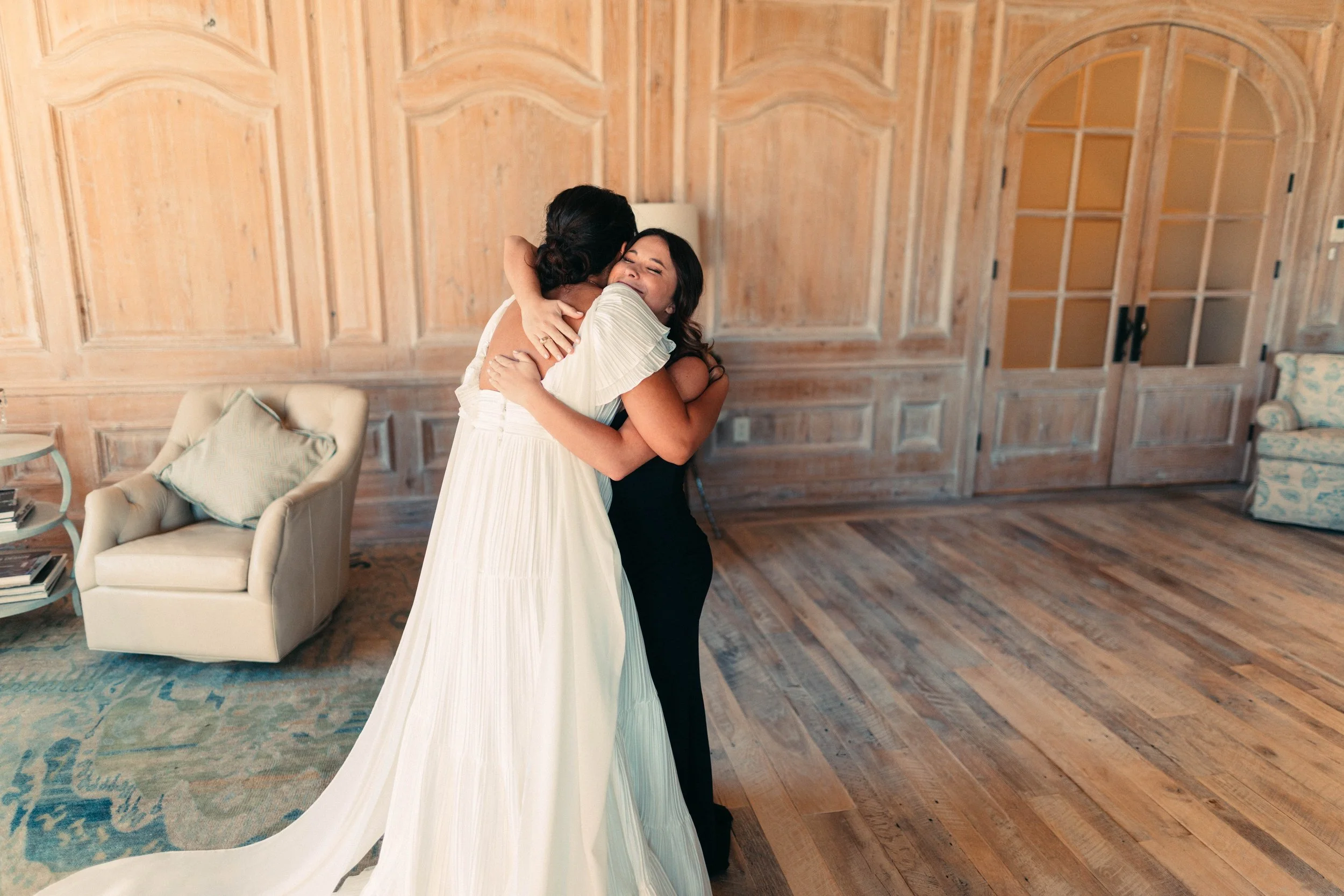 Bride sharing an emotional first look with her bridesmaids at Houston Oaks | documentary Austin travel wedding photographer.