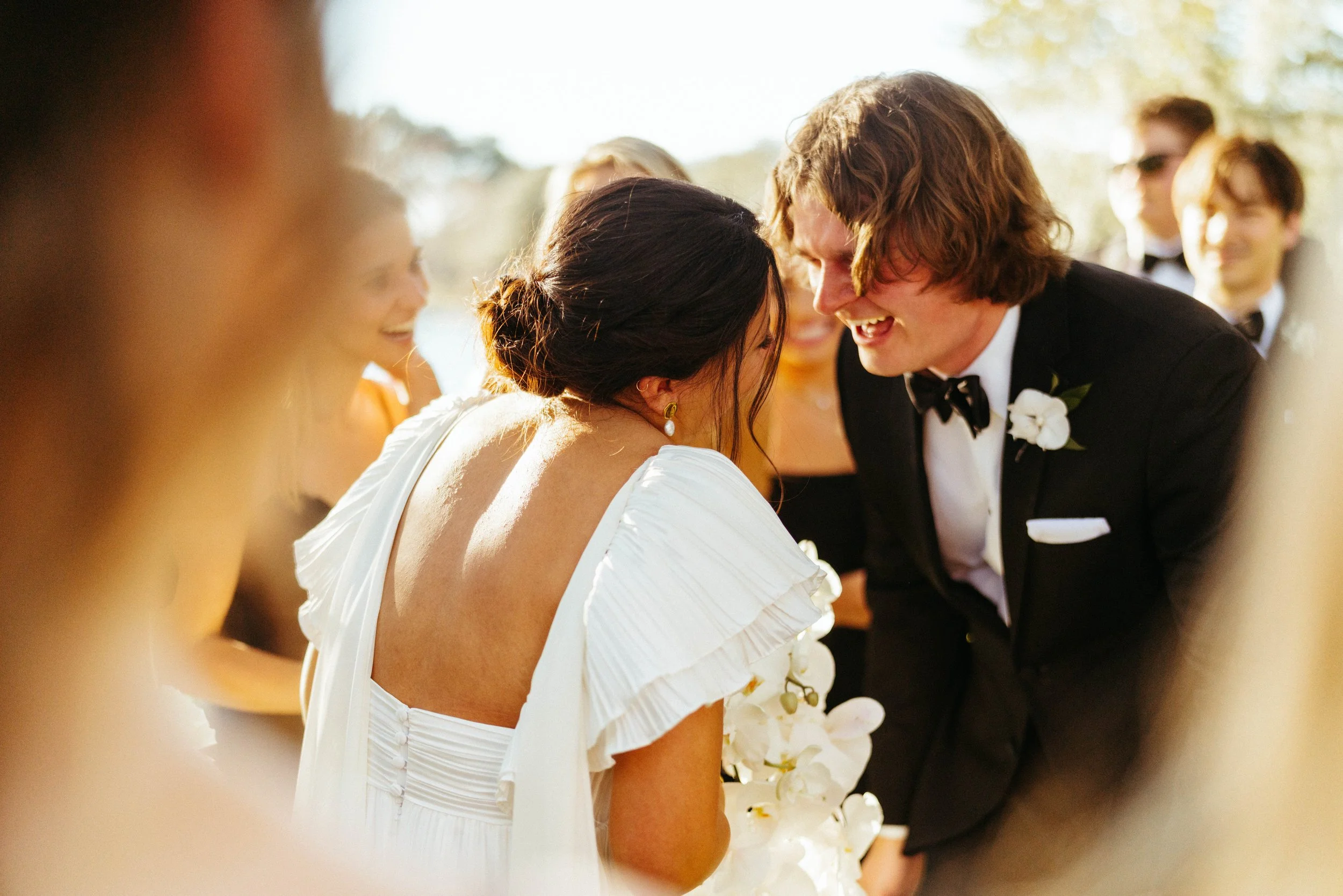 Newlyweds walking hand in hand near the historic French chapel | Austin travel wedding photographer.