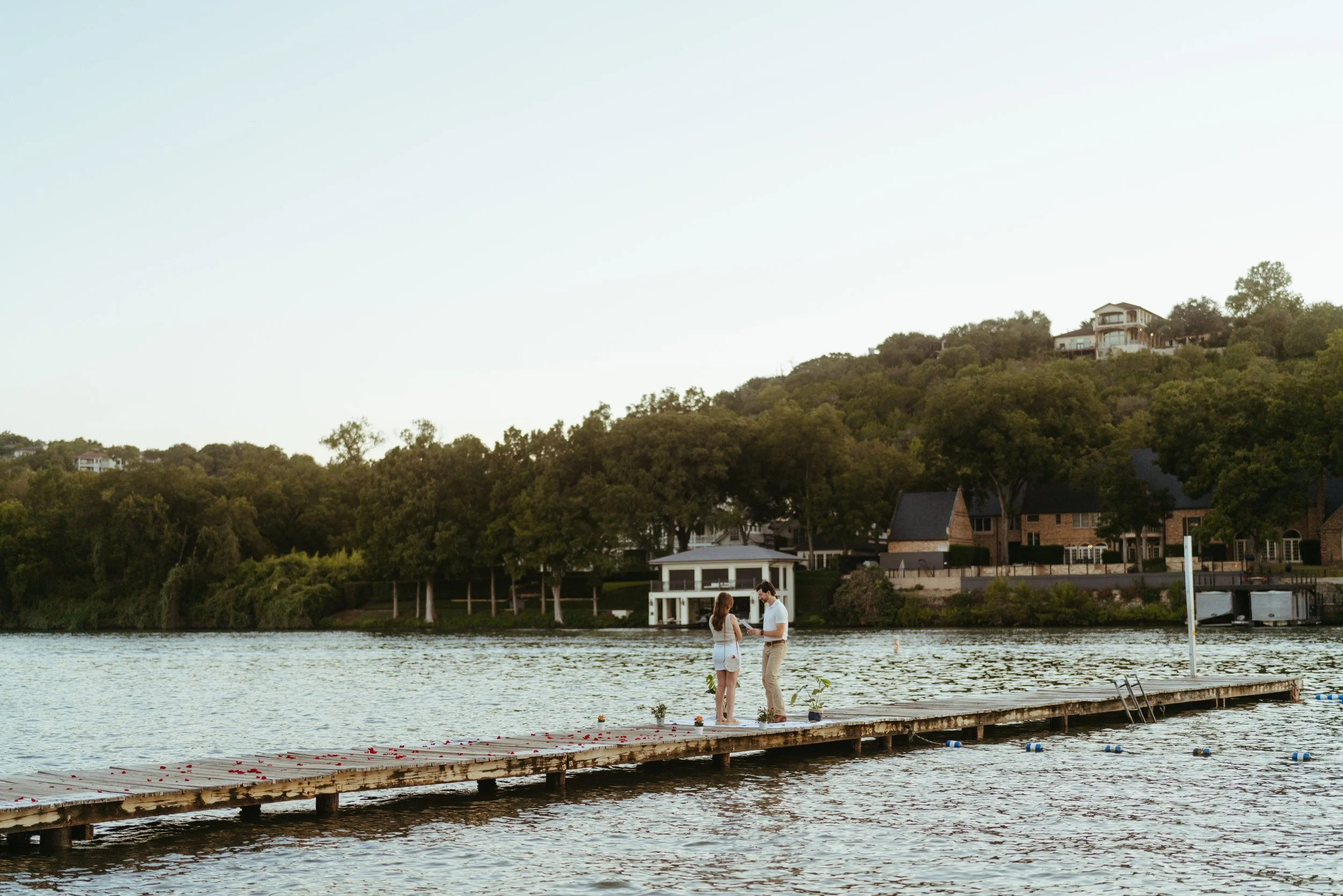 Austin engagement photography with couple holding hands on dock at Emma Long Park