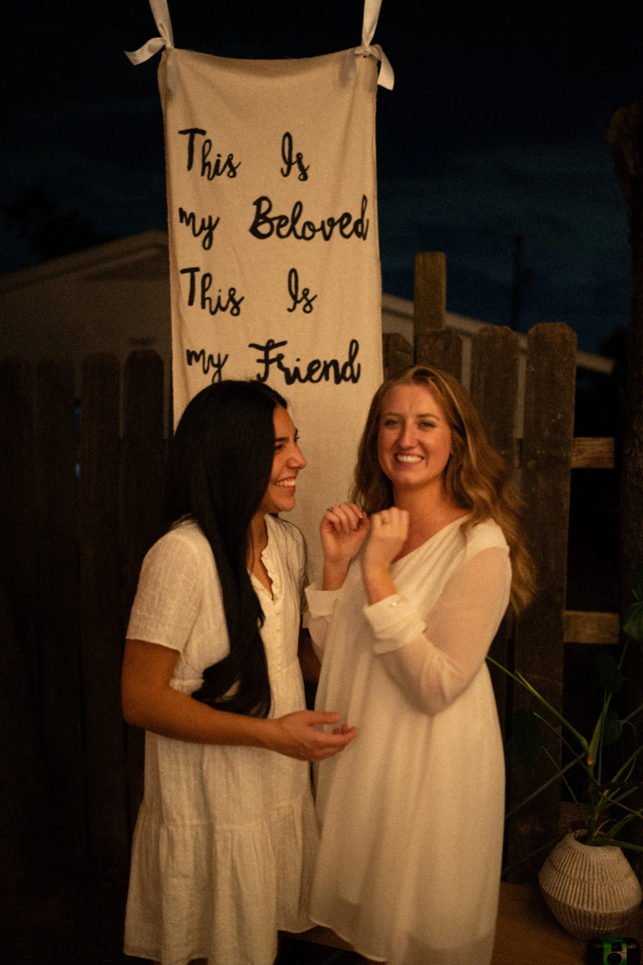 Documentary style wedding photography of couple celebrating engagement with loved ones