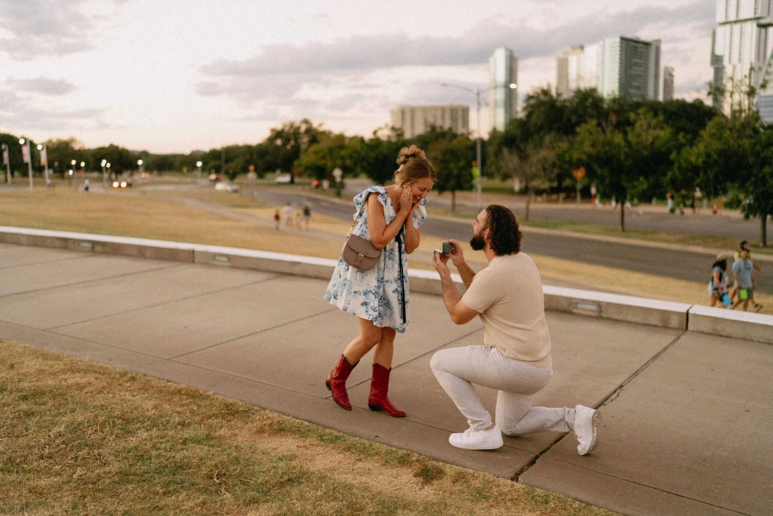Sunset proposal at Auditorium Shores in Austin captured by documentary style wedding photographer