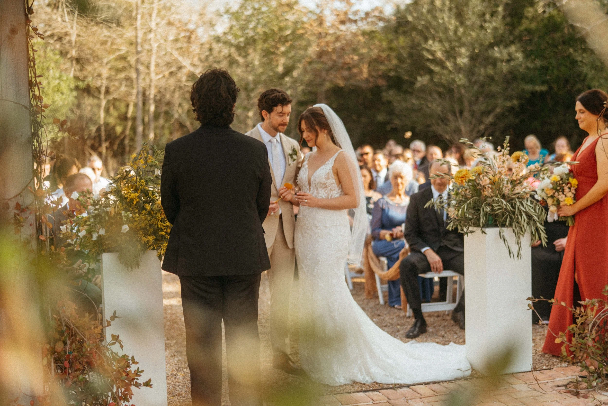 Couple taking communion during their Austin wedding ceremony at The Grand Lady pergola