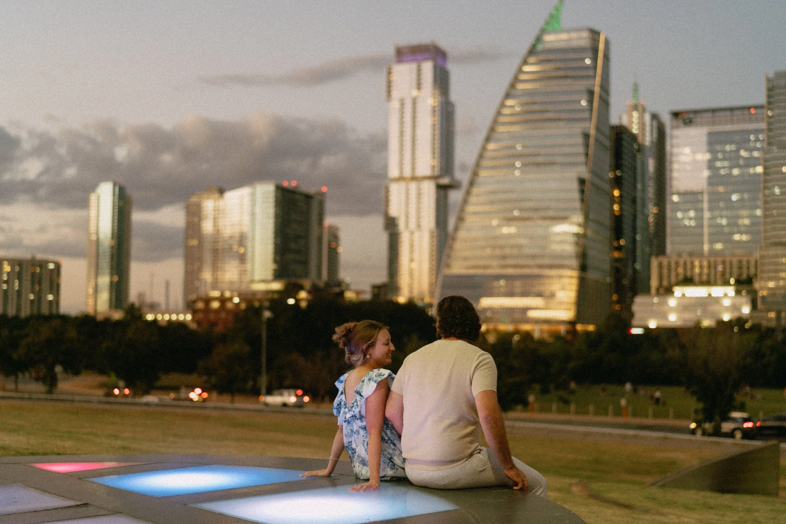 Bride-to-be surprised during proposal at Auditorium Shores with Austin skyline