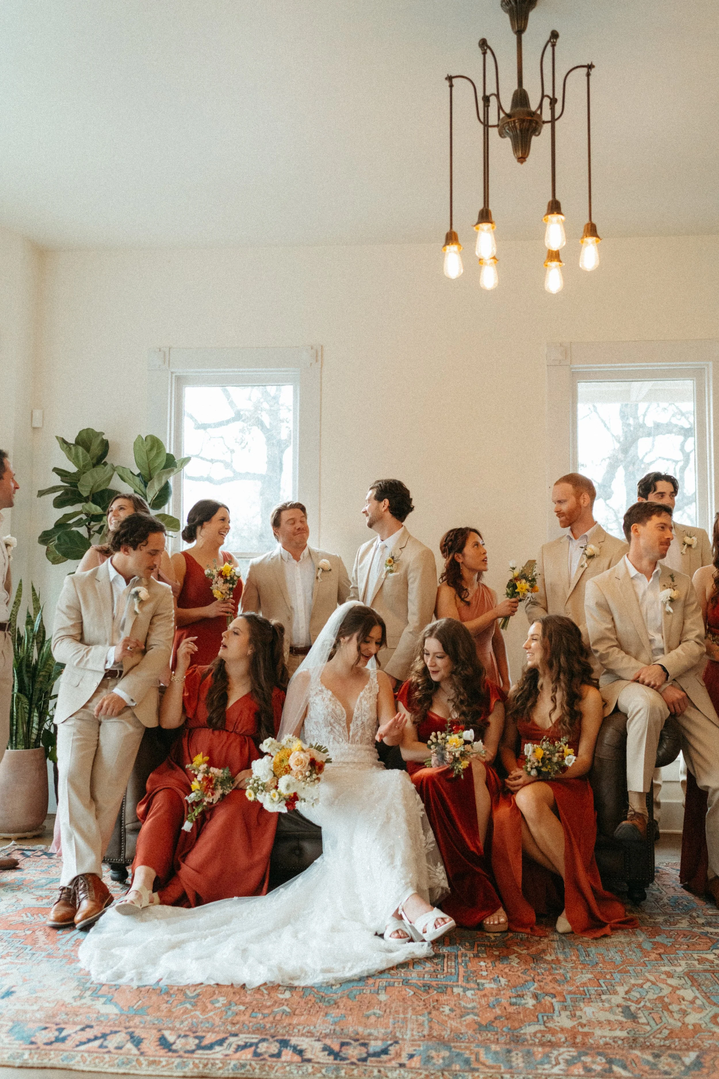 Vogue-style wedding party group photo inside The Grand Lady mansion living room