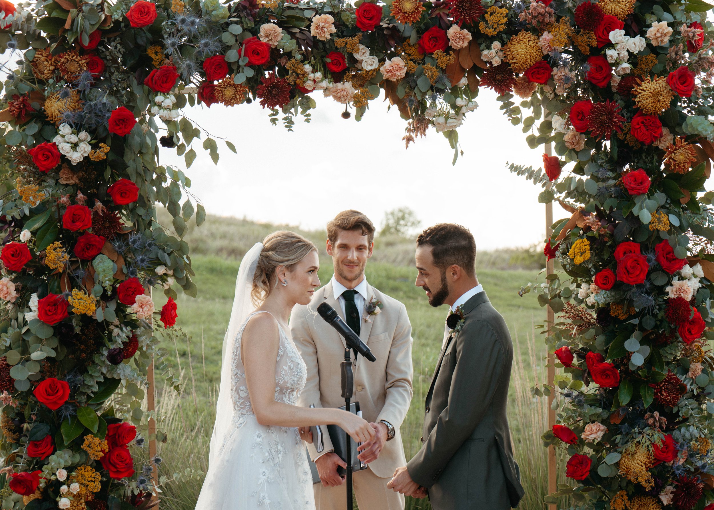 Beautiful floral arch with red roses and eucalpytus