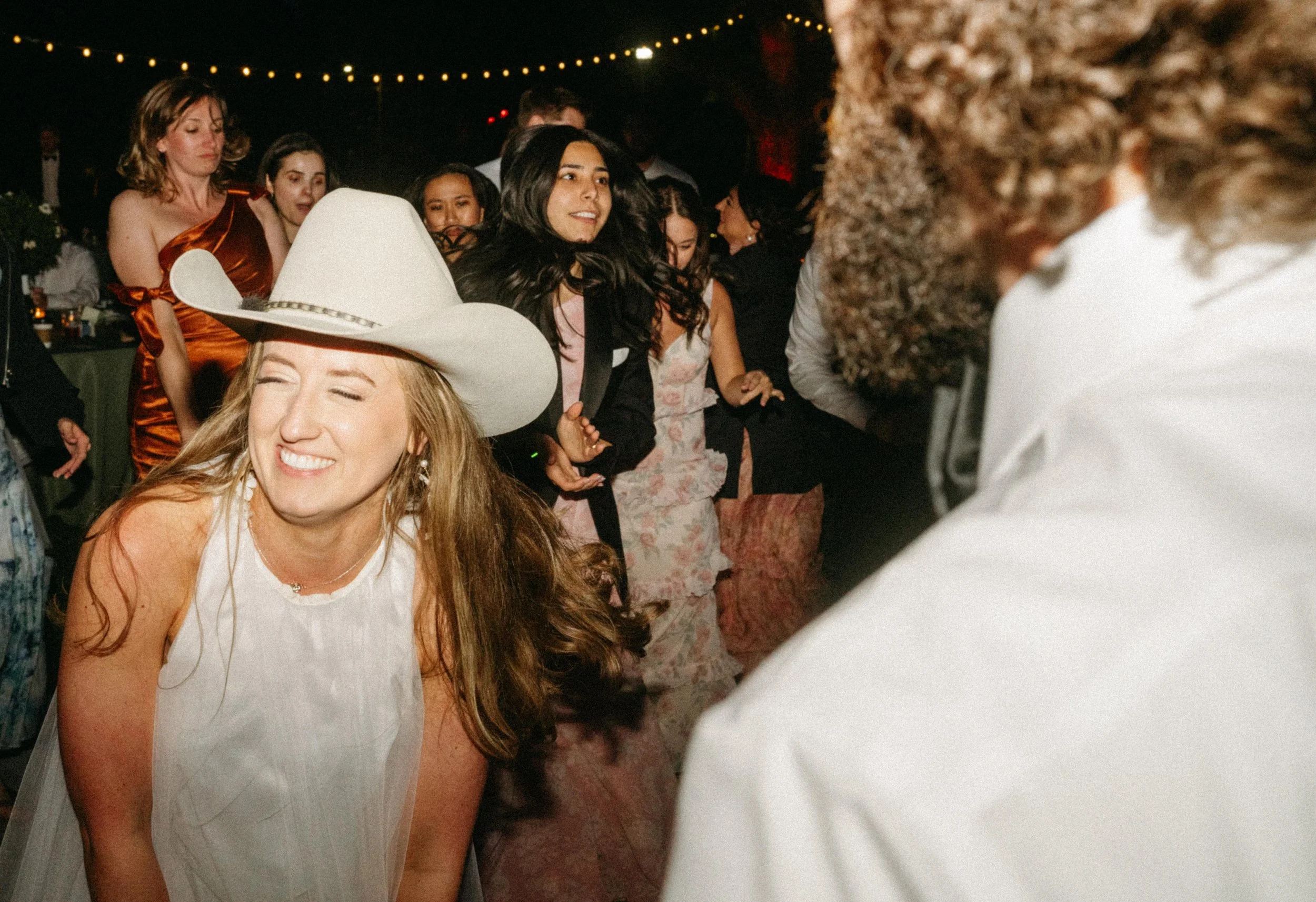 bride in cowboy hat dancing reception fun Texas wedding