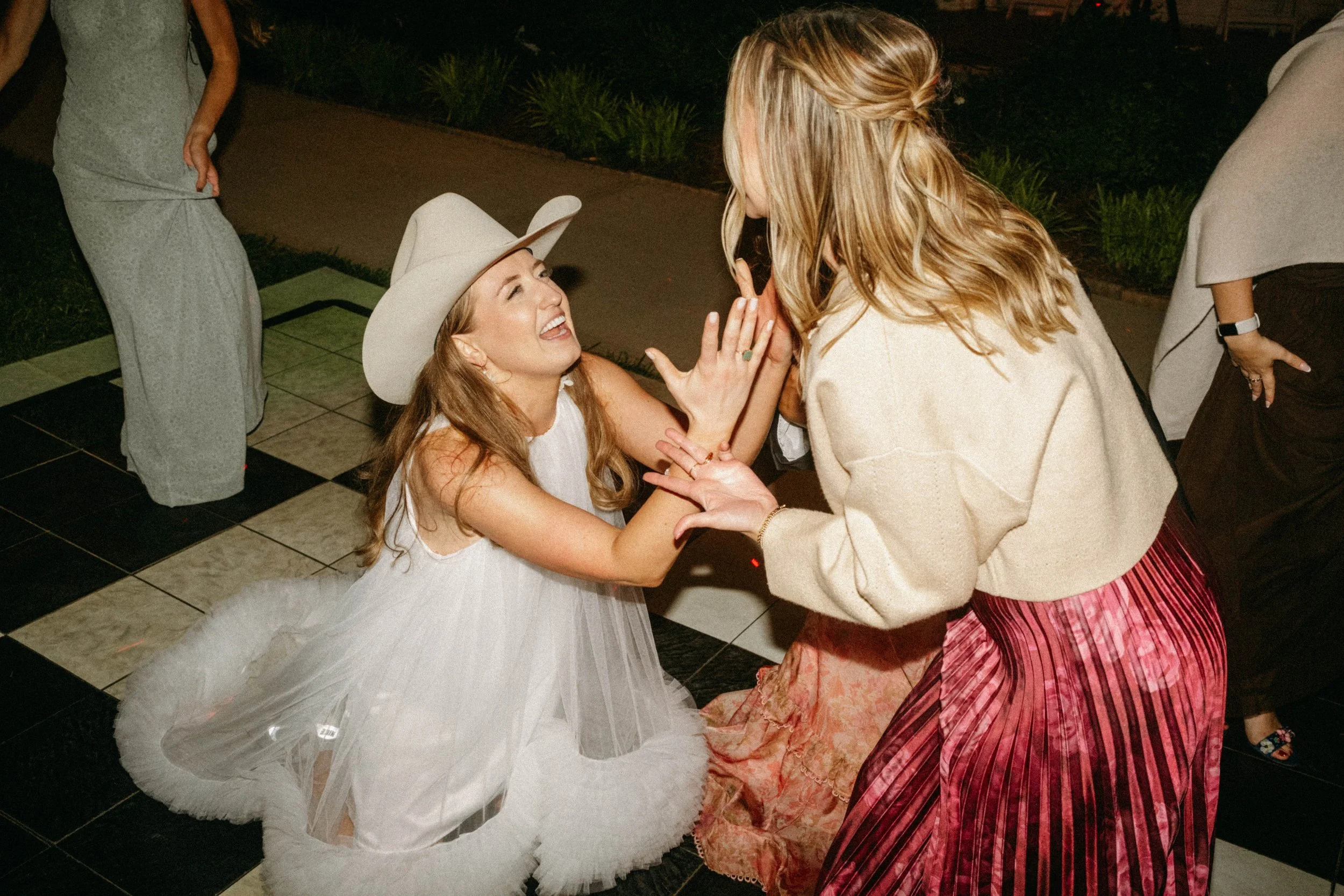bride celebrating with friends candid dance floor photo Texas